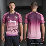 Model wearing Adidas x Stussy Japan Sakura Bloom Concept Jersey, a Touchline Drip football x streetwear jersey