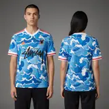 Model wearing Adidas x Stussy Japan Ocean Flow Concept Jersey - Blue Surge Edition, a Touchline Drip football x streetwear jersey