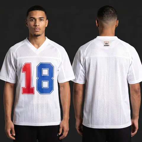 Model wearing Corteiz HMP Mesh Panel Jersey White, a Touchline Drip football x streetwear jersey