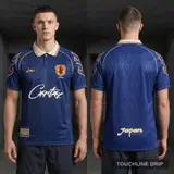 Model wearing Corteiz x Asics Japan 1998 Concept Jersey, a Touchline Drip football x streetwear jersey