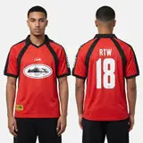 Model wearing Corteiz Red Alcatraz Jersey, a Touchline Drip football x streetwear jersey