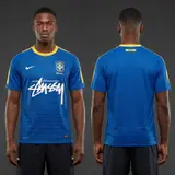 Model wearing Nike x Stussy Brazil Dynamic Blue Concept Jersey, a Touchline Drip football x streetwear jersey