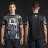 Model wearing Nike x Stussy Brazil Christ the Redeemer Concept Kit, a Touchline Drip football x streetwear jersey