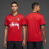 Model wearing Nike x Stussy Portugal Kit, a Touchline Drip football x streetwear jersey