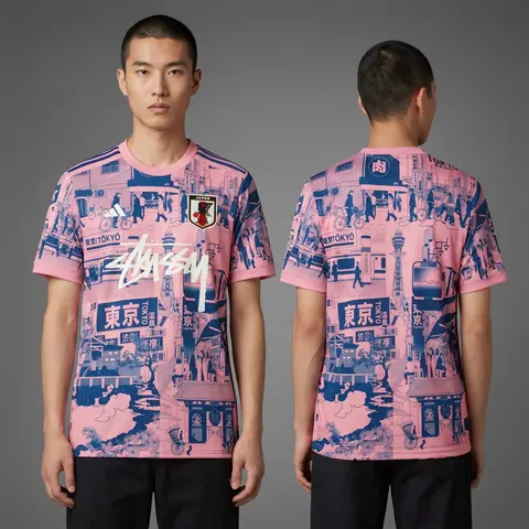Model wearing Stussy x Japan "tokyo Streetscape" Concept Jersey – Pink, a Touchline Drip football x streetwear jersey