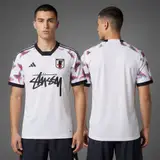 Model wearing Stussy x Japan White Sakura Jersey, a Touchline Drip football x streetwear jersey