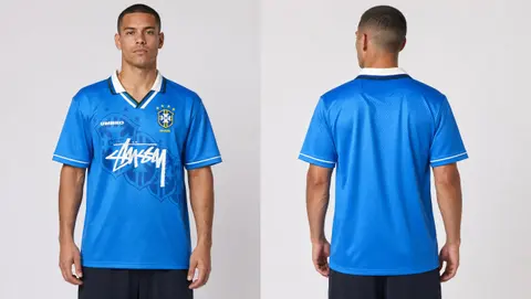 Model wearing Stussy x Umbro 96 Blue Away Jersey, a Touchline Drip football x streetwear jersey