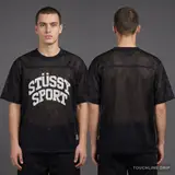 Model wearing Stussy Sport Mesh Jersey - Black, a Touchline Drip football x streetwear jersey