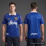 Model wearing Stussy x Asics Japan 1998 Concept Jersey, a Touchline Drip football x streetwear jersey