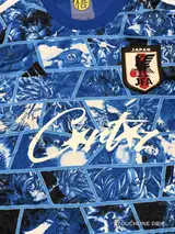 logo closeup product image of Adidas x Corteiz Japan Anime Fusion Light Blue Concept Jersey