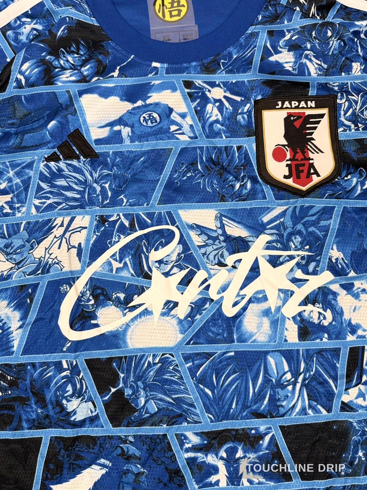logo closeup product image of Adidas x Corteiz Japan Anime Fusion Light Blue Concept Jersey