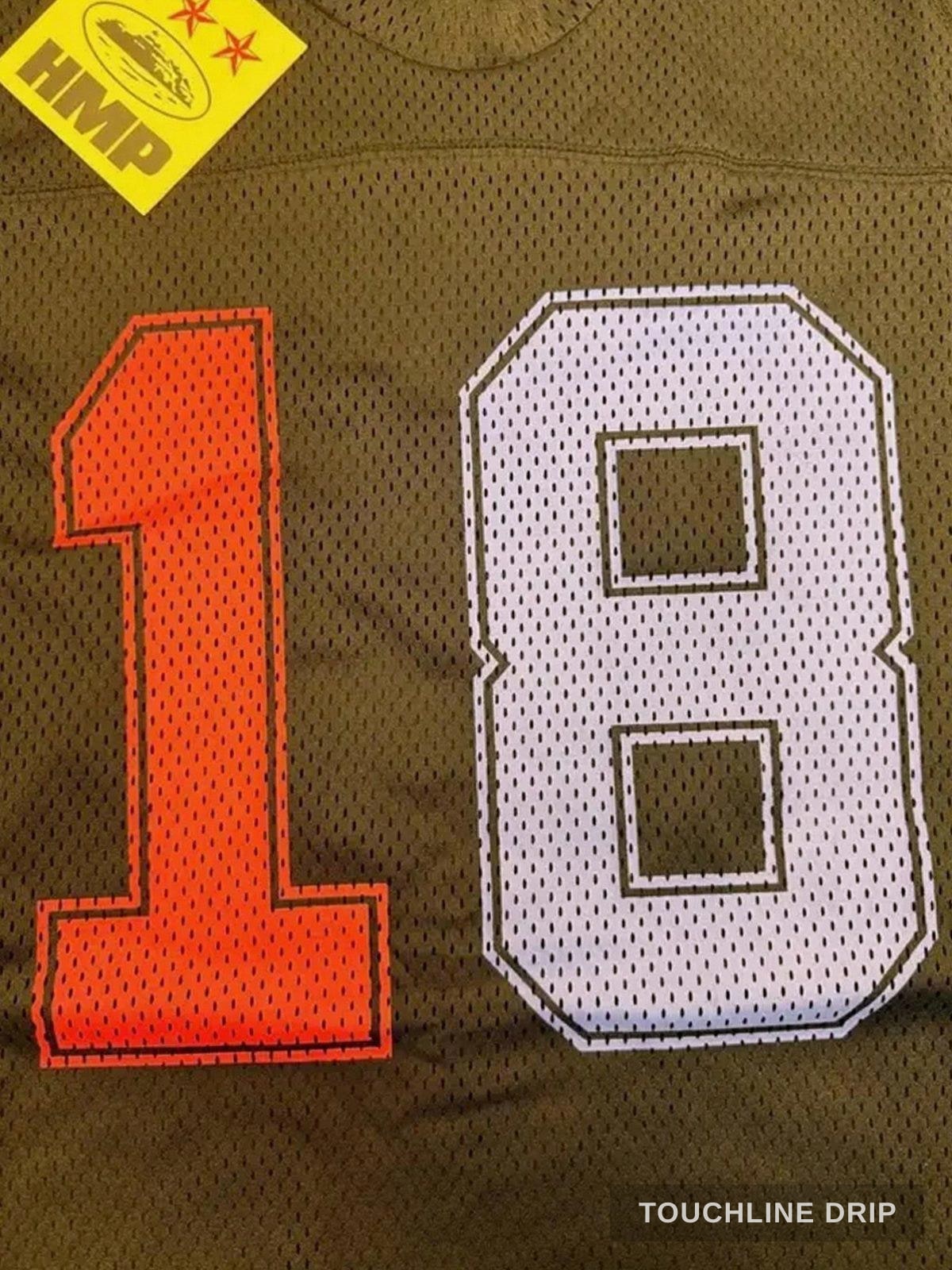 badge closeup product image of Corteiz HMP Mesh Panel Jersey Black