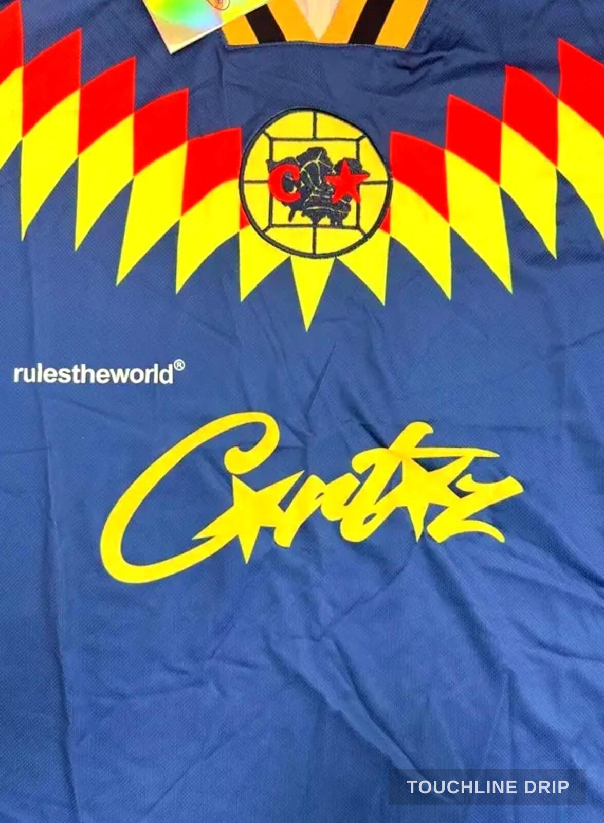 logo closeup product image of Corteiz Club América Blue Jersey