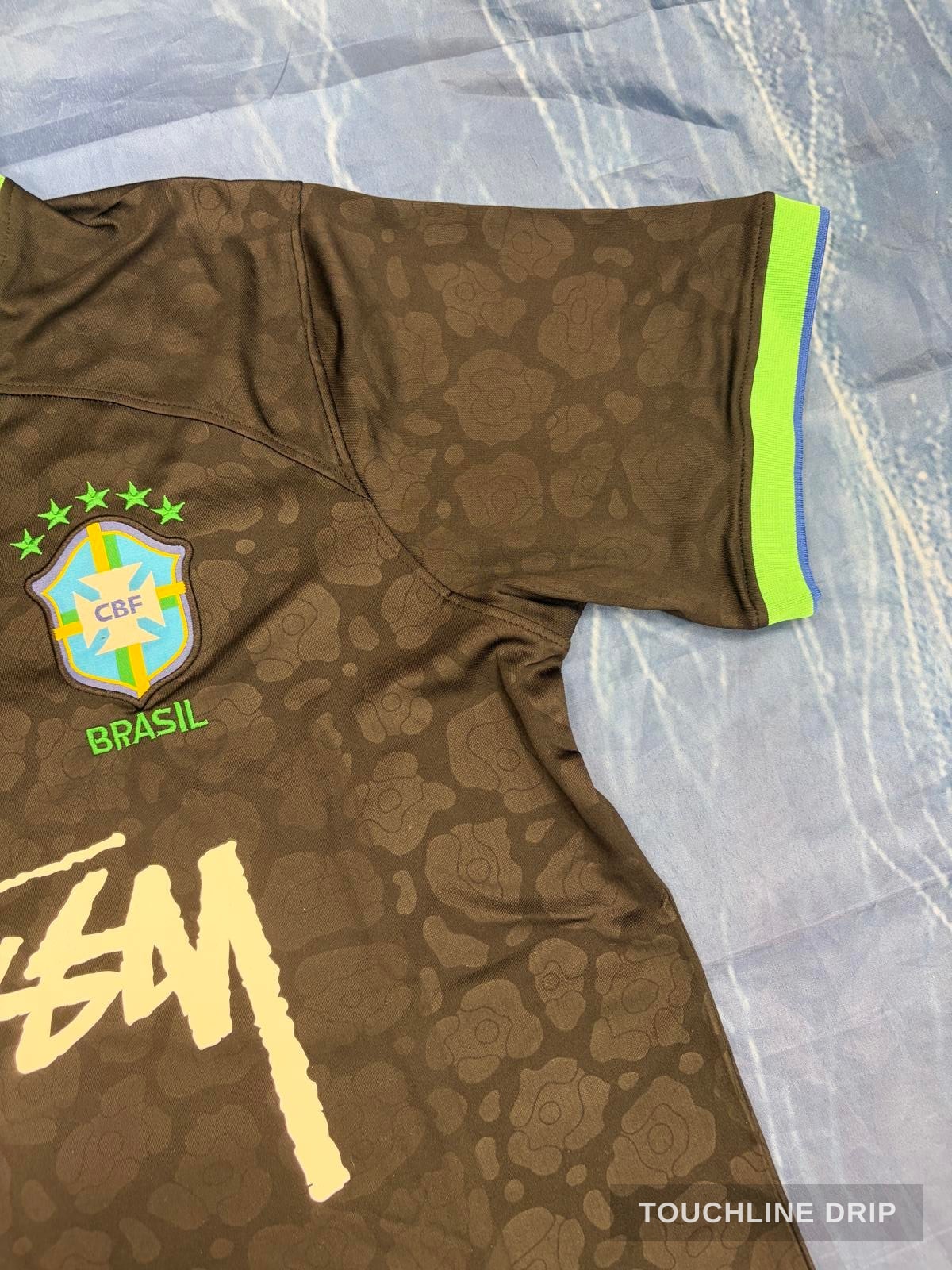 logo closeup product image of Nike x Stussy Brazil Black Leopard Concept Jersey