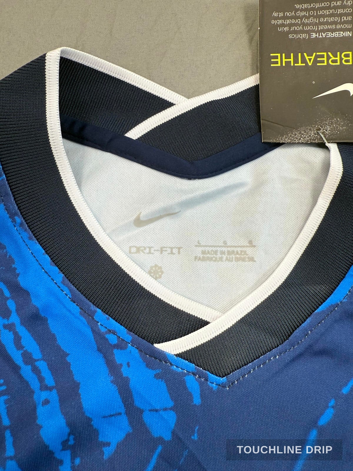 logo closeup product image of Nike x Stussy Brazil Mid Blue Leaf Print Concept Jersey