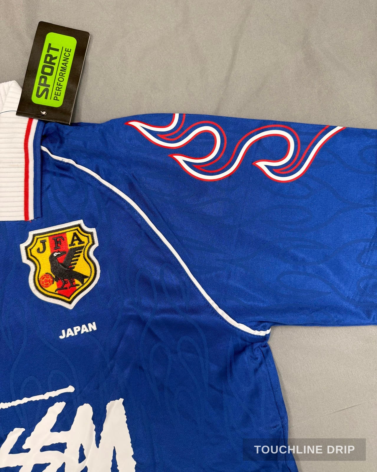 badge closeup product image of Stussy x Asics Japan 1998 Concept Jersey
